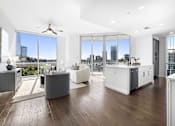 Thumbnail 23 of 80 - A modern living room with a large window overlooking the city.