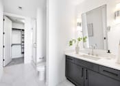 Thumbnail 49 of 80 - A bathroom with a white sink and a mirror.