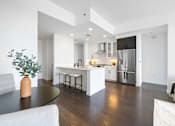 Thumbnail 63 of 80 - A modern kitchen with a black table and white cabinets.