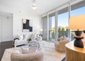Thumbnail 64 of 80 - A living room with a white couch and a grey armchair.