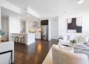 Thumbnail 60 of 80 - A modern kitchen with white cabinets and a large island.