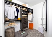 Thumbnail 54 of 80 - A white shirt is hanging on a hanger in a closet.