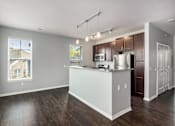Thumbnail 10 of 26 - A kitchen with a white counter and brown cabinets.