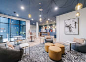 Thumbnail 4 of 28 - A modern lounge area with a variety of seating options and a large window.
