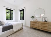 Thumbnail 22 of 28 - A bedroom with a bed, dresser, and mirror.