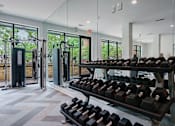 Thumbnail 10 of 28 - A gym with a row of dumbbells on a rack.