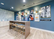 Thumbnail 6 of 28 - A room with a blue wall and a row of chairs.