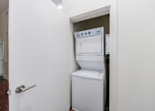 Thumbnail 25 of 28 - A white oven and dishwasher in a small kitchen.