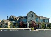 Thumbnail 45 of 50 - a large house with a parking lot in front of it