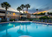 Thumbnail 1 of 38 - apartments with a large swimming pool at dusk
