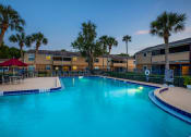 Thumbnail 5 of 38 - a swimming pool with palm trees and apartments in the background
