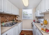 Thumbnail 20 of 38 - a kitchen with white cabinets and a sink