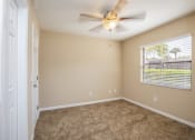 Thumbnail 23 of 38 - an empty bedroom with a ceiling fan and a window
