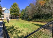 Thumbnail 33 of 38 - a yard with a fence and a house in the background
