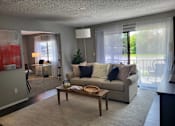 Thumbnail 15 of 31 - A living room with a couch, coffee table, and sliding glass doors  at Waterview at Rocky Point, Florida