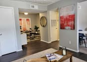 Thumbnail 19 of 31 - A living room with a wooden coffee table and a painting on the wall  at Waterview at Rocky Point, Florida