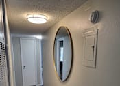 Thumbnail 20 of 31 - A hallway with a mirror and a light switch  at Waterview at Rocky Point, Florida