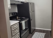 Thumbnail 11 of 31 - A kitchen with a black oven and refrigerator  at Waterview at Rocky Point, Florida