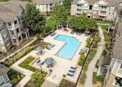 Thumbnail 15 of 30 - an aerial view of a swimming pool in an apartment complex