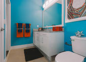 Thumbnail 24 of 35 - a bathroom with blue walls and a white toilet and sink