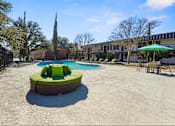 Thumbnail 25 of 28 - A round green and white hot tub sits in the middle of a concrete courtyard.