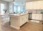 Thumbnail 9 of 50 - a large kitchen with white cabinets and a counter top