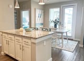 Thumbnail 10 of 50 - an open kitchen and dining room with a table and chairs