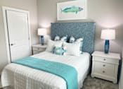 Thumbnail 14 of 50 - a blue and white bedroom with a bed and a fish
