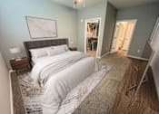 Thumbnail 19 of 31 - A bedroom with a large bed and a painting on the wall.