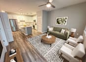 Thumbnail 16 of 31 - A modern living room with a green couch and a coffee table.
