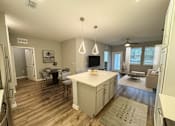 Thumbnail 21 of 31 - A kitchen with a dining table and chairs.