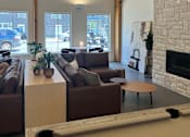 Thumbnail 11 of 15 - a living room with a couch and a table