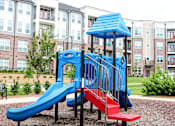 Thumbnail 44 of 53 - A blue and red slide in a playground with a blue roof.