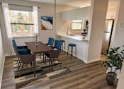 Thumbnail 15 of 38 - A dining room with a wooden table and blue chairs.
