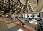 Thumbnail 35 of 43 - A gym with a variety of equipment including treadmills, weights, and a rowing machine.