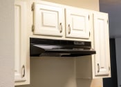 Thumbnail 19 of 43 - a kitchen with white cabinets and an oven and a microwave
