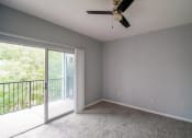 Thumbnail 17 of 31 - a living room with a ceiling fan and a sliding glass door