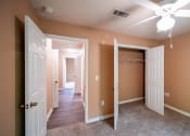 Thumbnail 44 of 69 - a bedroom with a closet and a ceiling fan