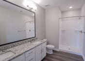 Thumbnail 21 of 48 - A bathroom with a toilet, sink, and shower.