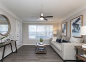 Thumbnail 10 of 27 - a living room with a ceiling fan and a large window at Crestmont at Thornblade, South Carolina