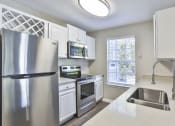 Thumbnail 14 of 27 - a kitchen with white cabinets and stainless steel appliances at Crestmont at Thornblade, South Carolina, 29615
