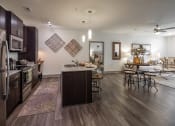 Thumbnail 19 of 37 - a kitchen and living room with a dining area and a table with chairs