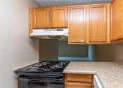 Thumbnail 14 of 41 - a kitchen with white cabinets and black appliances