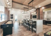 Thumbnail 5 of 37 - a kitchen with a long bar and a dining table