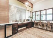 Thumbnail 7 of 37 - a kitchen with a counter and chairs in front of a window