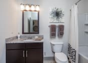 Thumbnail 24 of 37 - a bathroom with a sink and a toilet and a shower