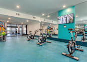 Thumbnail 13 of 29 - A room with exercise bikes and a television.