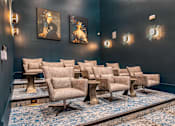 Thumbnail 24 of 29 - A row of chairs are lined up in a room with blue carpet.