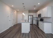 Thumbnail 11 of 23 - a kitchen with white cabinets and stainless steel appliances