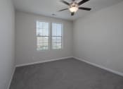 Thumbnail 15 of 23 - a bedroom with gray walls and a ceiling fan